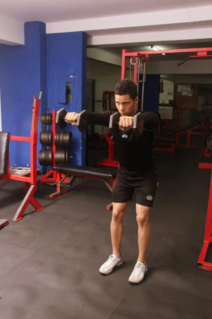 Haciendo elevacion frontal para homro en el gimnasio